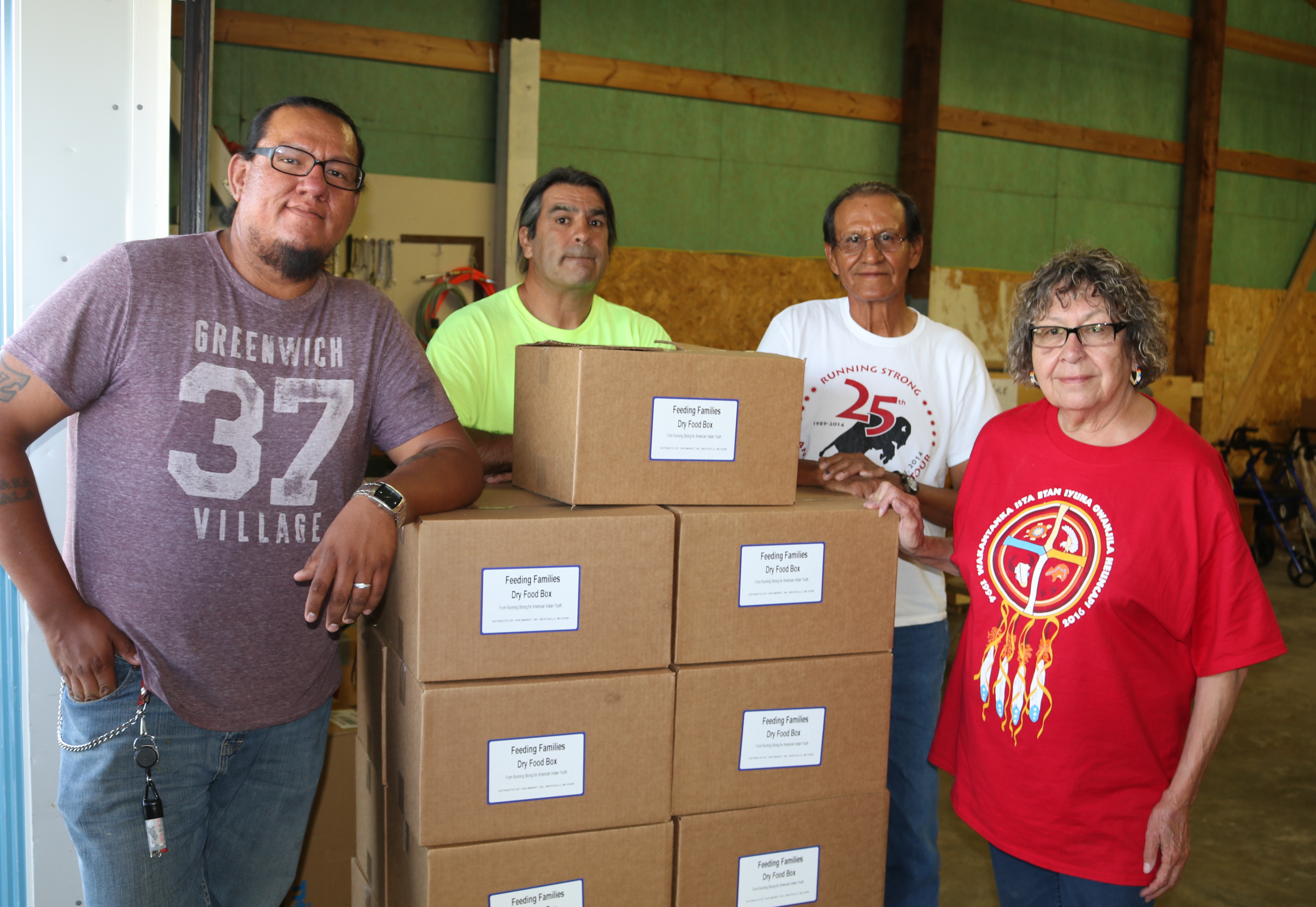 Volunteers with dry food boxes at community distribution site