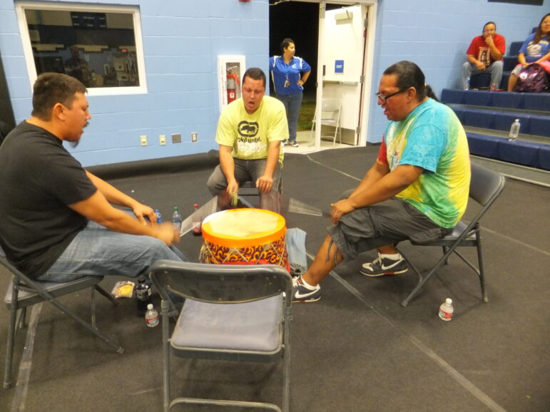 Dave Lone Elk (right) drums at a local powwow.