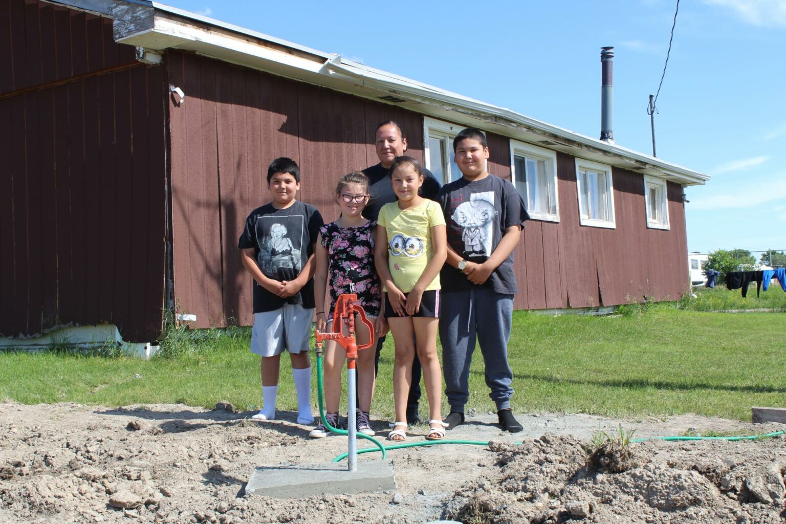 Native American family getting access to clan water.