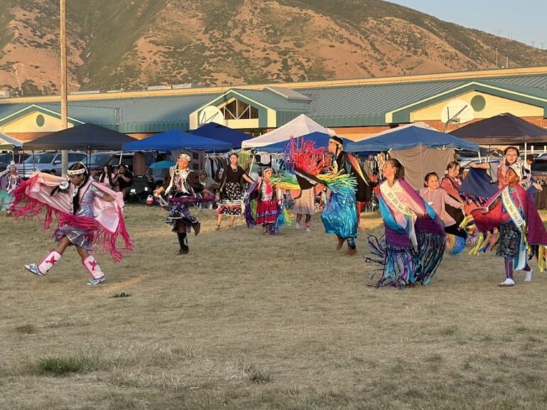 Community members in regalia dance at a Pow-wow, a cultural event supported by Dreamstarter Teacher Analysa Allison.