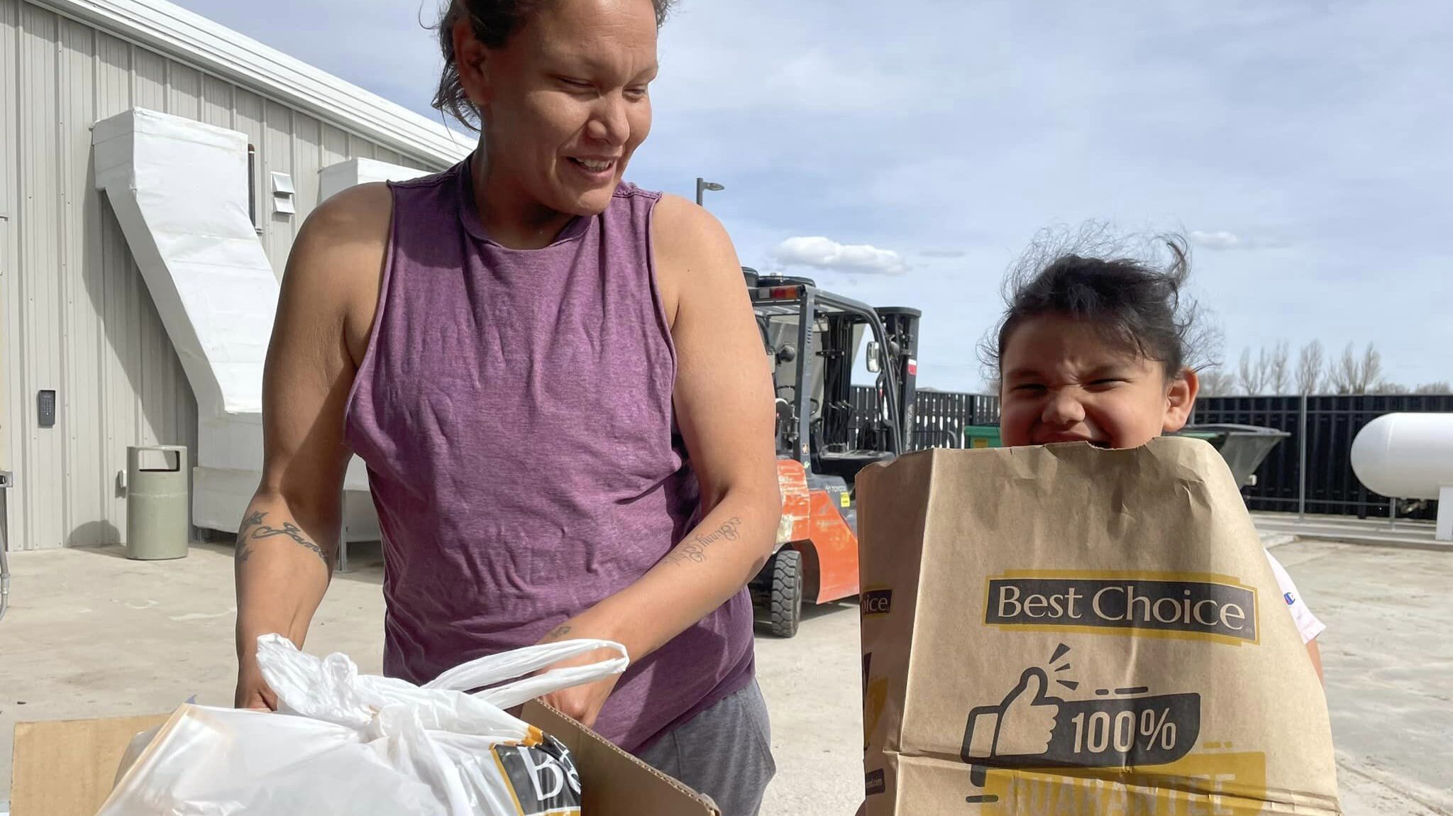 Mother and daughter receiving food supplies through the Native American Food Sovereignty program