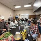 Community members gather at a Lumbee Food Collective workshop to learn about traditional Lumbee foods, root vegetables, and cultural food practices.