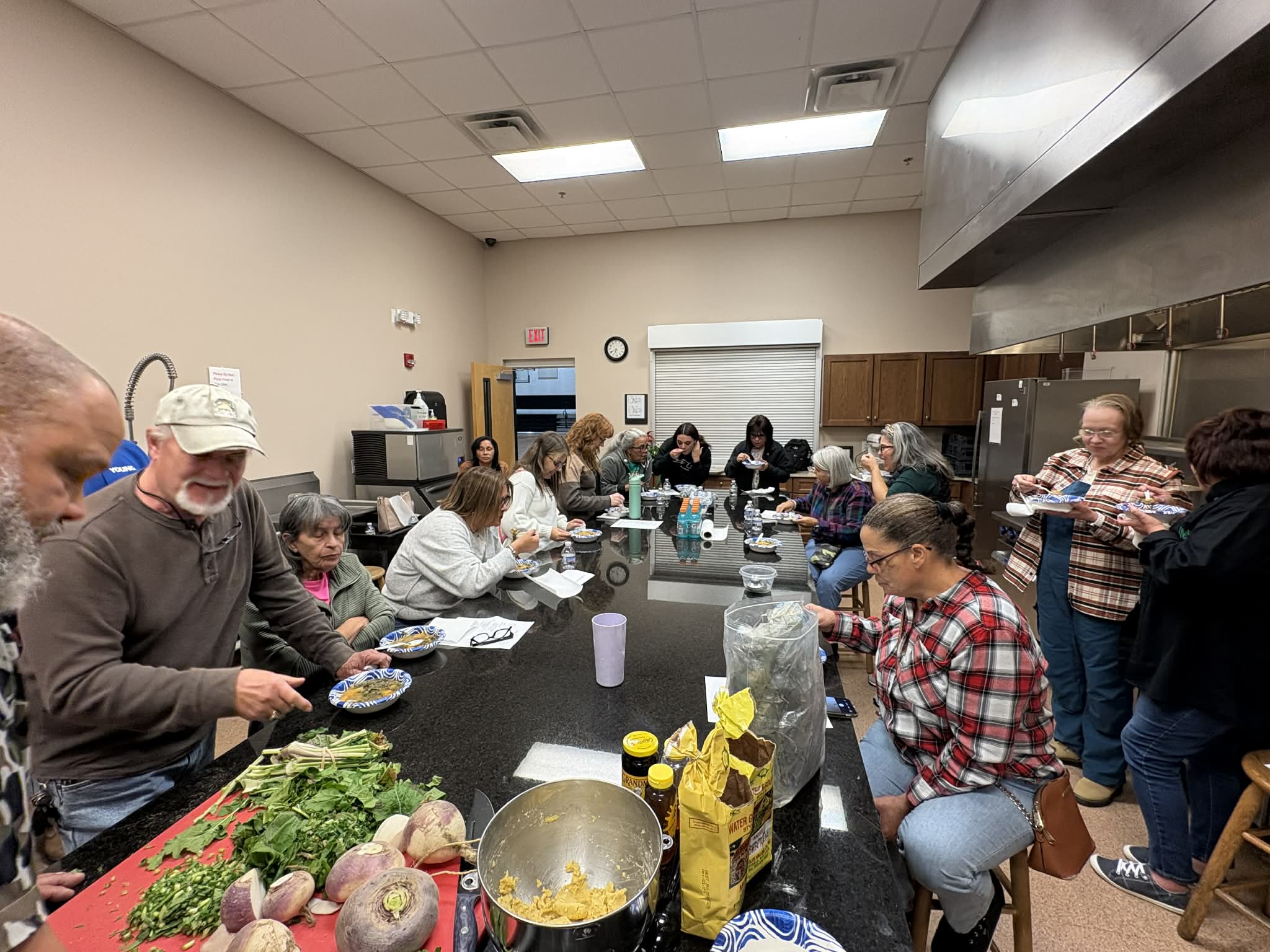 Community members gather at a Lumbee Food Collective workshop to learn about traditional Lumbee foods, root vegetables, and cultural food practices.