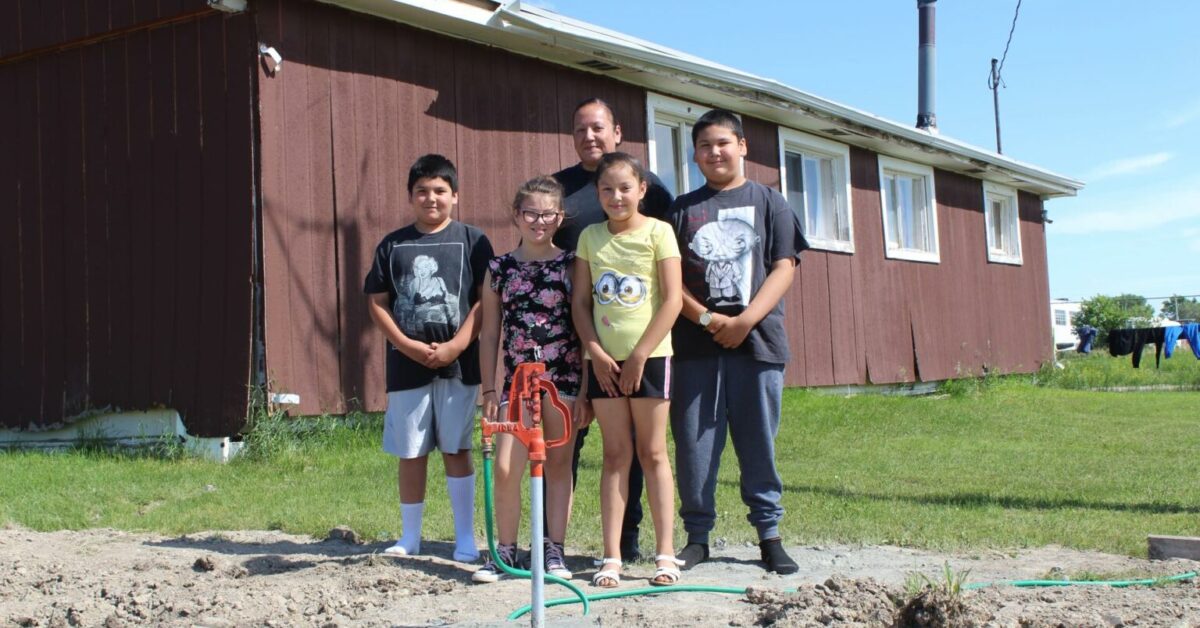 Native American family getting access to clan water.