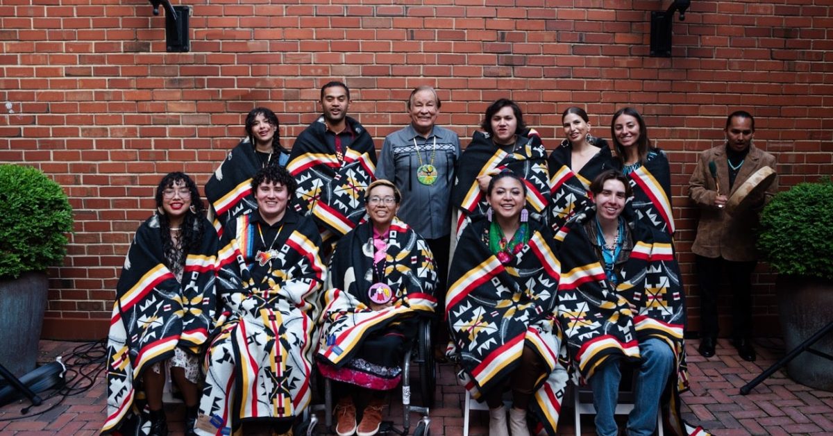 Group of 2024 Dreamstarter participants wearing traditional Native blankets.